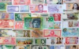 An Australian $100 note sits alongside currencies from around the world.