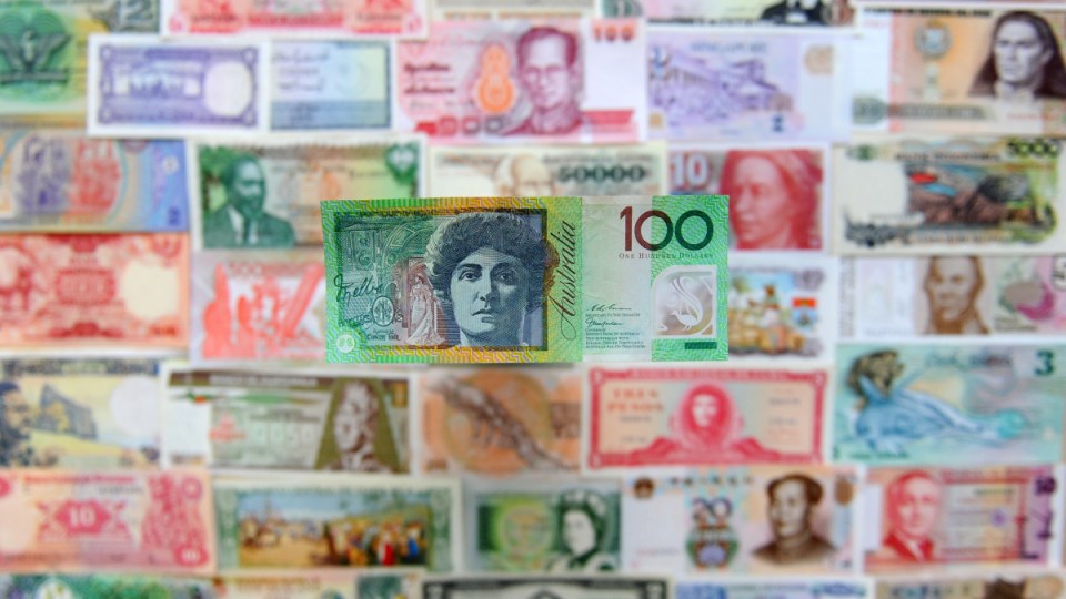 An Australian $100 note sits alongside currencies from around the world.