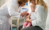 doctor giving vaccination to small child