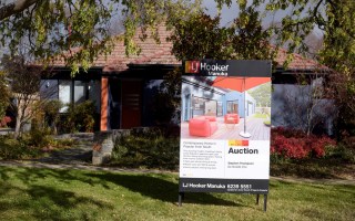 a house with an auction sign