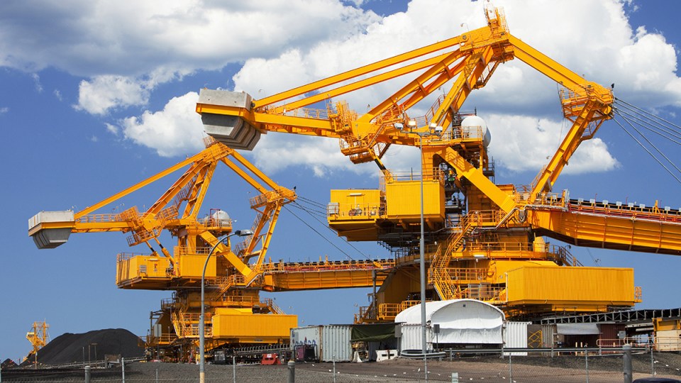 Two large diggers dredge coal up from the soil.