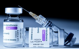 This picture shows vials of the AstraZeneca Covid-19 vaccine and a syringe in Paris on March 11, 2021. - European countries can keep using AstraZeneca's coronavirus vaccine during an investigation into cases of blood clots that prompted Denmark, Norway and Iceland to suspend jabs, the EU's drug regulator said on March 11, 2021.