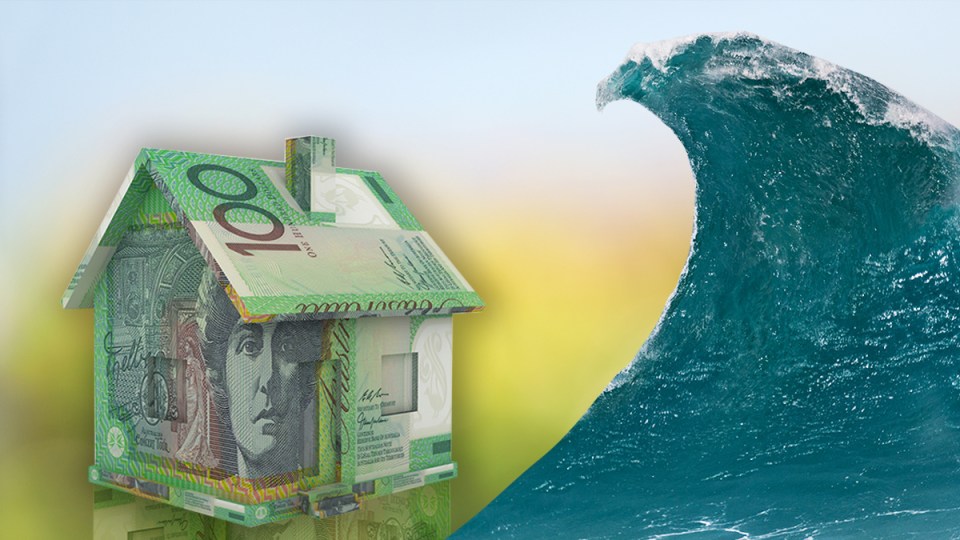 A house made of money about to be wiped out by a huge wave.