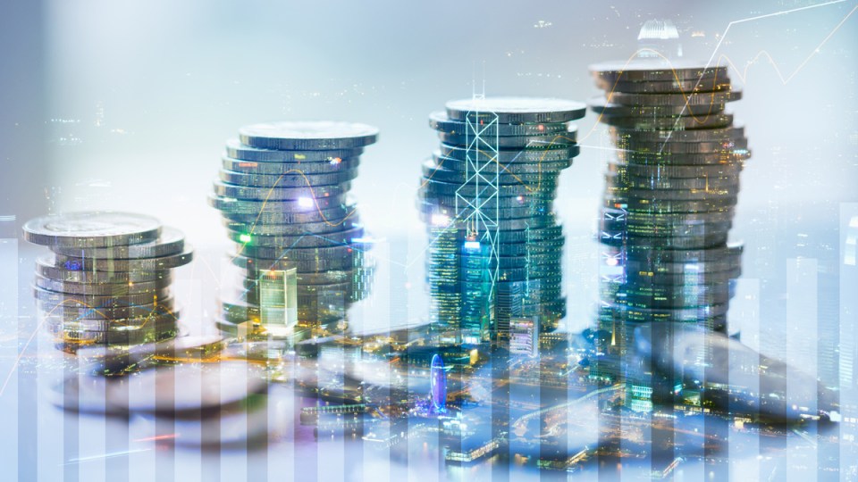 Coins overlaid with digital finance imagery.