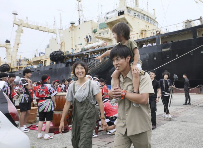 Families of the crew celebrate their return on Tuesday.