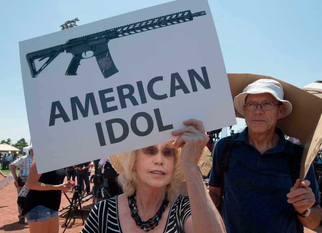 Protestor holds anti-gun sign.