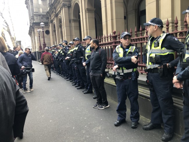 People waiting outside though the large police presence was an omen. Photo: TND