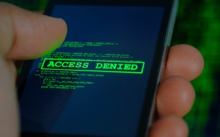 A mobile phone that reads 'access denied'.
