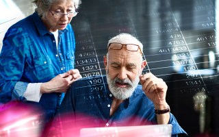 Old people in front of calculations