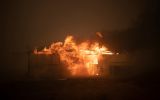 A bushfire ravages property near Canberra.