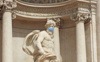 The god Neptune in a mask, in one of the most famous fountains in Rome and in the world, the Trevi Fountain. . Italy is one of the countries hardest hit by the coronavirus pandemic