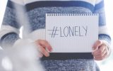 Woman holding a #lonely sign. This is to illustrate the loneliness of the Coronavirus stay at home order.