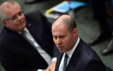 Treasurer Josh Frydenberg (right) reacts alongside Prime Minister Scott Morrison (left) during Question Time in the House of Representatives