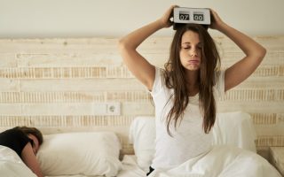 woman in bed with burnout