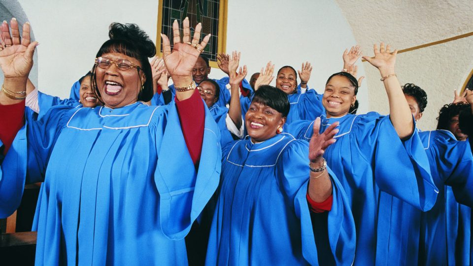 Twelve Gospel Singers With Raised Hands Singing in a Church Service - stock