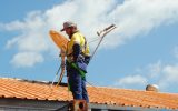 a satellite dish being installed on a roof