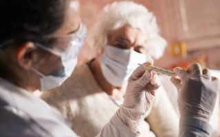 doctor doing medical exam to a senior woman