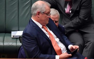 Prime Minister Scott Morrison and Deputy Prime Minister Michael McCormack confer during Question Time in the House of Representatives at Parliament House on June 11, 2020 in Canberra, Australia
