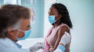 Close up of a young woman getting vaccinated