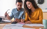 Australian couple in their 30s filling out their tax returns
