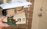 Amazon prime boxes and envelopes delivered to a front door of residential building - stock photo