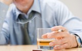 Man drinking whisky and smoking