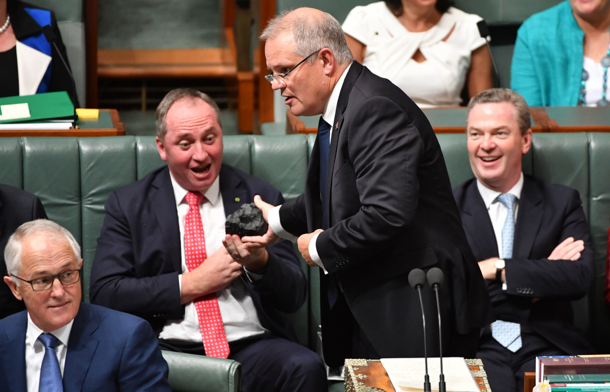Treasurer Scott Morrison hands Deputy Prime Minister Barnaby Joyce a lump of coal during Question Time in the House of Representatives at Parliament House in Canberra, Thursday, Feb. 9, 2017. (AAP Image/Mick Tsikas) NO ARCHIVING