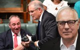 Treasurer Scott Morrison hands Deputy Prime Minister Barnaby Joyce a lump of coal during Question Time in the House of Representatives at Parliament House in Canberra, Thursday, Feb. 9, 2017
