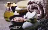 Fresh and dry lavender flowers.stones as heart shape. essential oil. pink salt. bath towel. aromatic candle on textured background.