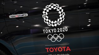 An Olympics games logo is seen on a displayed car at Toyota showroom in Tokyo on November 6, 2020