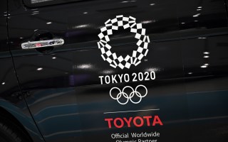An Olympics games logo is seen on a displayed car at Toyota showroom in Tokyo on November 6, 2020
