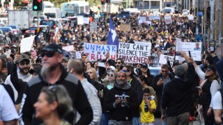 Protesters march along Broadway and George St towards Sydney Town Hall during the ‘World Wide Rally For Freedom’ anti-lockdown rally at Hyde Park in Sydney, Saturday, July 24, 2021.