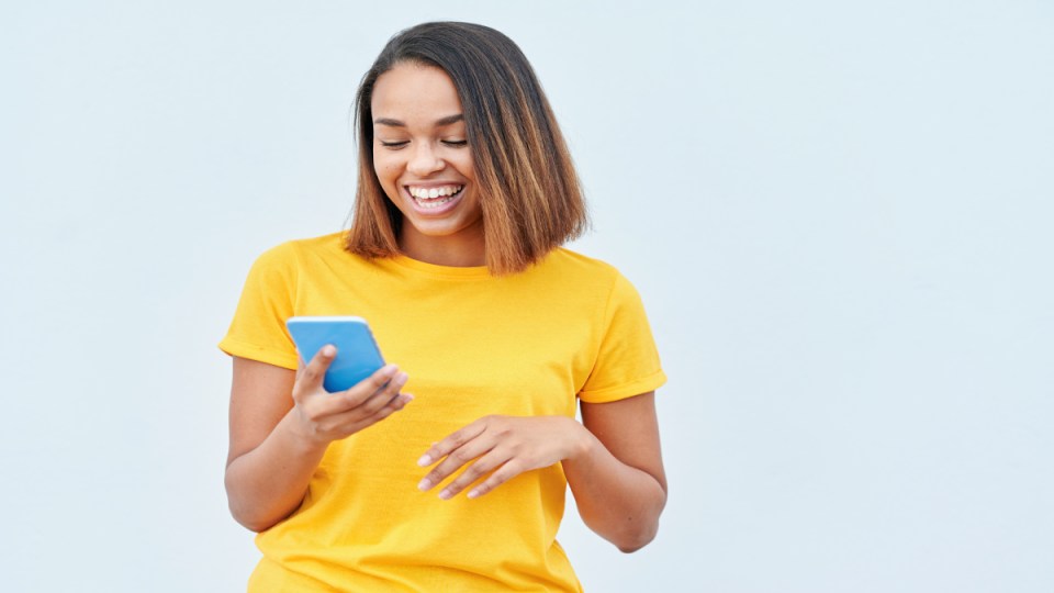 A woman looking at a mobile phone.