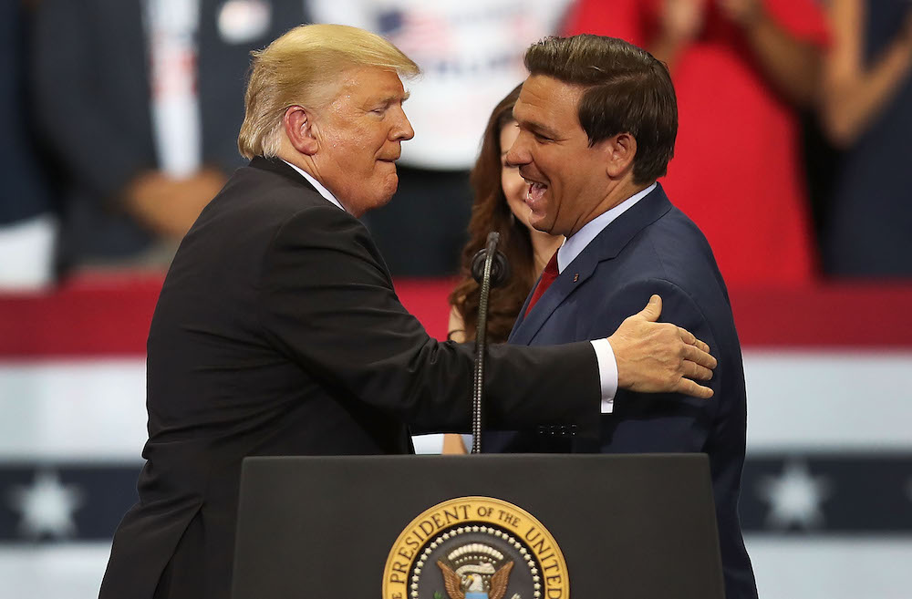 Pictured is Donald Trump and Ron DeSantis, the Murdoch empire's seemingly new favourite Republican