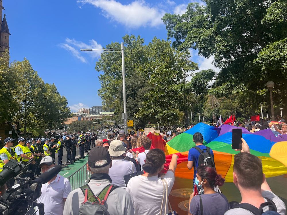 Pictured are protestors outside George Pell's funeral.
