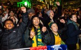 Pictured are people watching the Matildas