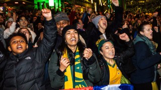 Pictured are people watching the Matildas