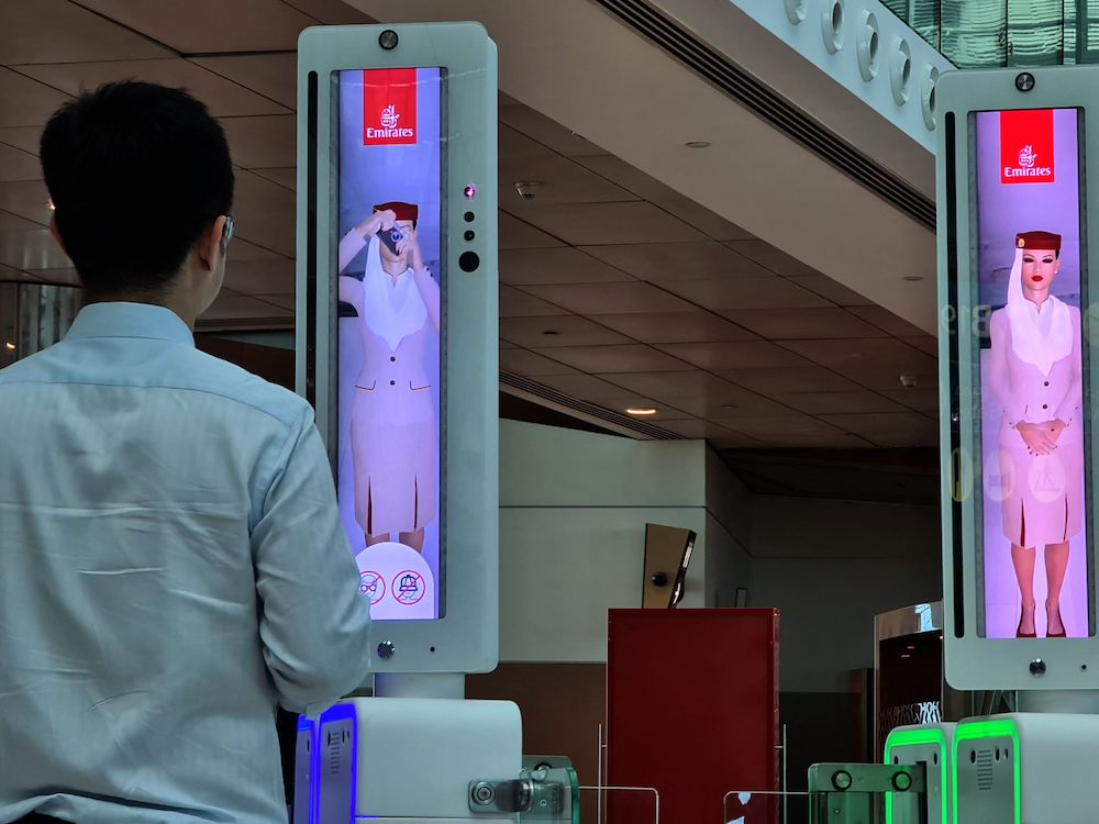 A passenger crosses a newly deployed fast-track gate that uses face and iris-recognition technologies at Dubai international airport, on March 7, 2021. - The new biometric system has been deployed at 122 smart gates at arrival and departure terminals for first class passengers. 