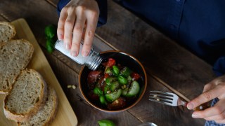 pictured is someone adding salt