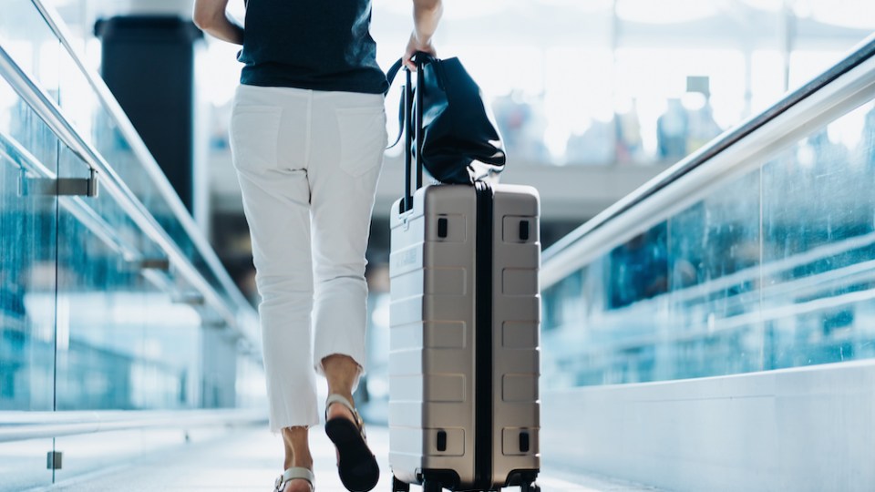 pictured is someone at the airport to represent travel insurance