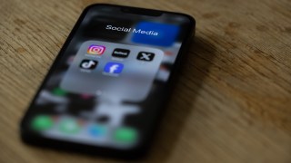 Pictured is a phone with social media apps.