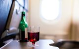 pictured is a drink of alcohol on a plane